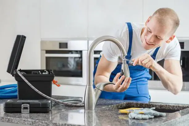 Plumber replacing a cartridge during faucet repair on a bathroom sink in a Bradenton, FL home