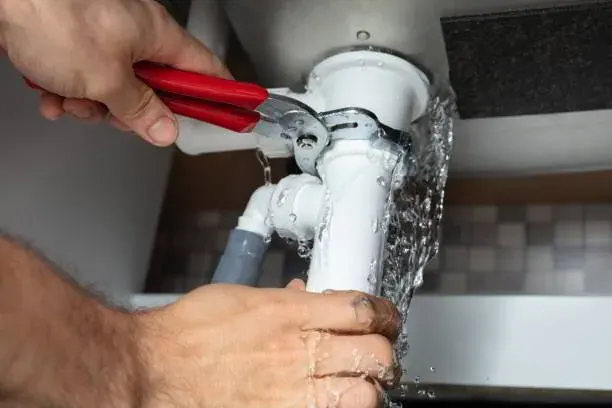 Technician using acoustic equipment during leak detection services on a tile floor