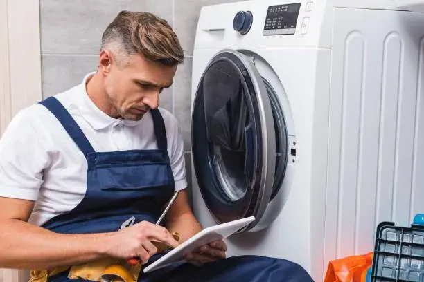 Plumber installing a recessed valve box for washing machine plumbing in a Bradenton, FL laundry room